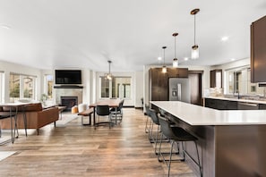 A spacious kitchen with a large island, modern appliances, and pendant lighting.
