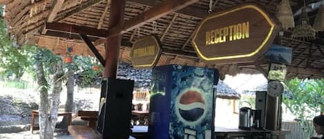 A reception area with a sign labeled 'RECEPTION' and a Pepsi logo on the wall.