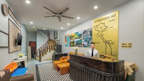 A reception area with a reception desk, a map on the wall, and a staircase leading to another floor. - Hanoi Old quarter Central Hotel (Hanoi)