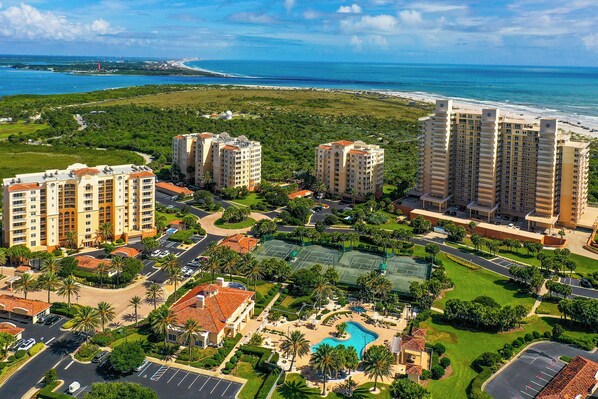 A resort with multiple high-rise buildings, a swimming pool, and a beach view. - Beachfront Bliss by the Surf | Inlet #605 (New Smyrna Beach)