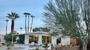 A modern house with a patio area, outdoor seating, and a fire pit. - 
Your Borrego Bungalow: 2BR/2BA at Roadrunner Golf and C.C. Golf cart included! (Borrego Springs)