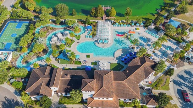 An aerial view of a resort with a swimming pool, tennis court, and multiple villas. - Spacious 5BR Villa w/ Private Pool – near Disney! (Kissimmee)