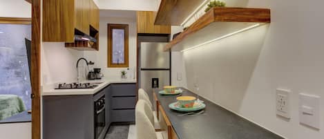 Craft gourmet vacation meals in a contemporary culinary space featuring a built-in oven, modern cooktop, and a spacious breakfast bar.