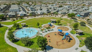 A residential area with houses, a playground, and a swimming pool.