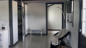 A room with a bed, a desk, a chair, a window, and a door.