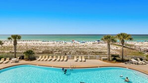 A poolside view with a beach and ocean in the background. - 3BR ~ Beachfront ~ Huge Balcony ~ 2 Pools ~ Luxury (Fort Walton Beach)
