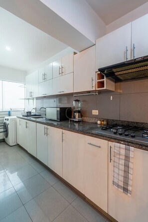 Fridge, microwave, coffee/tea maker, cookware/dishes/utensils
