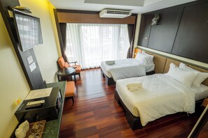 A hotel room with two beds, a desk with a computer, a TV, and a window with curtains. - Landmark Nakhon Phanom Hotel (Nakhon Phanom)