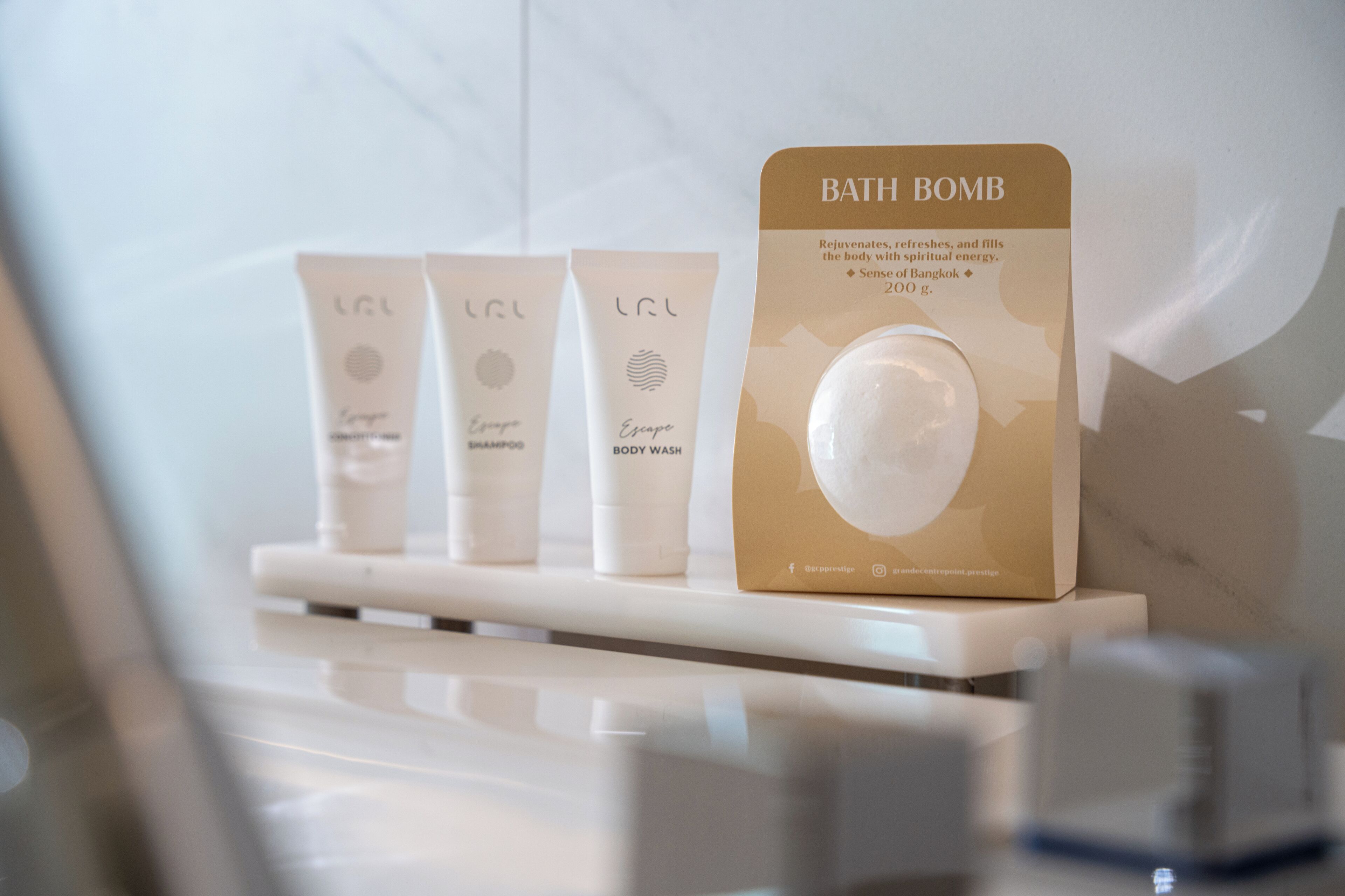 A bathroom shelf with a product display for 'Bath Bomb' and three tubes labeled 'LCL'.