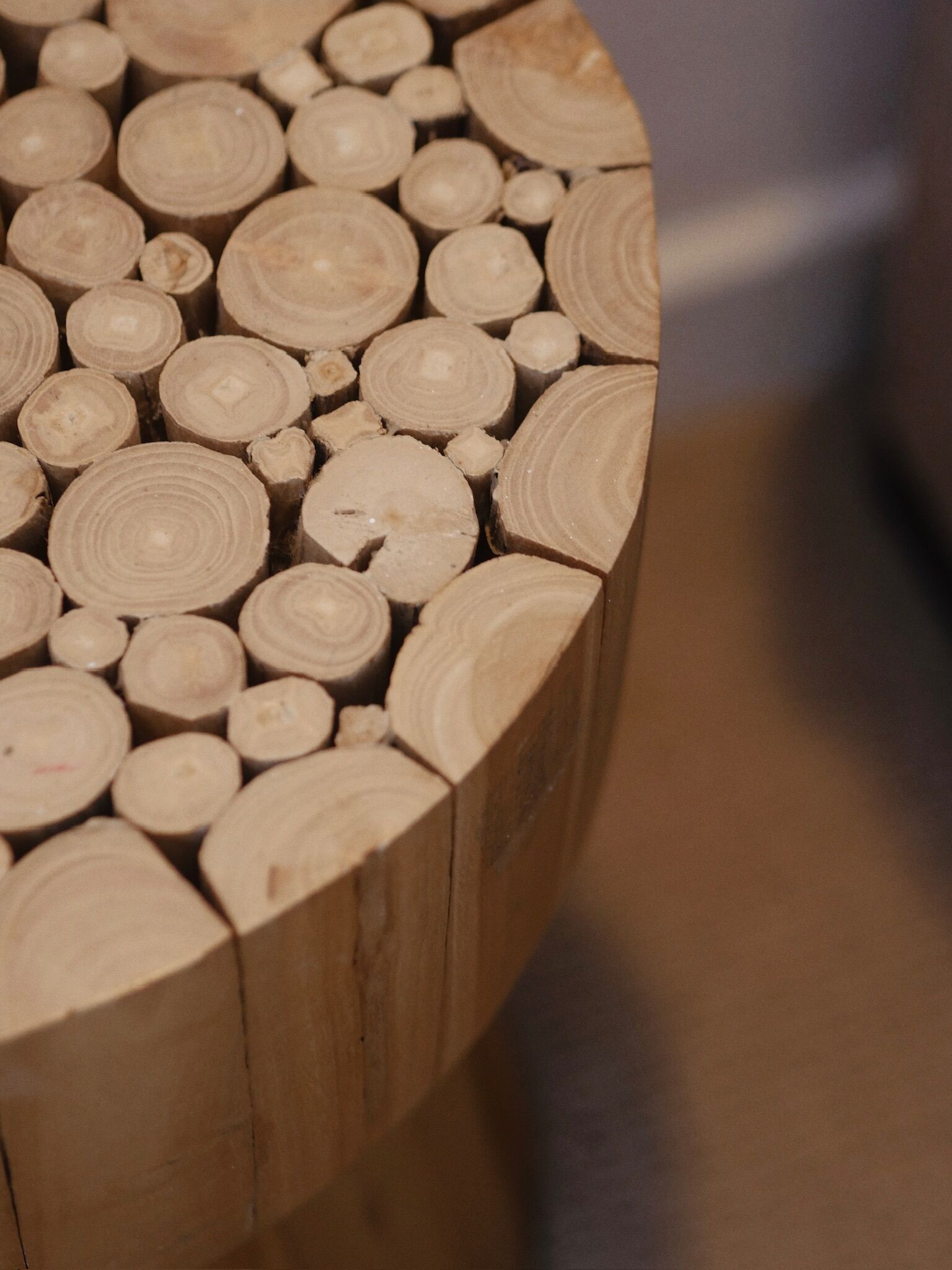 A close-up of a wooden structure with multiple circular cross-sections.