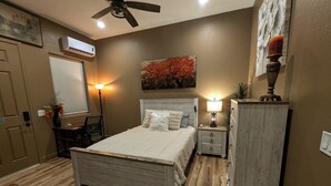A bedroom with a bed, bedside table, lamp, dresser, and a ceiling fan. - Suite #2 Full Private Studio - Brand New! (Clovis)