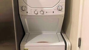 A front view of a white washing machine in a laundry room. - Suite #2 Full Private Studio - Brand New! (Clovis)