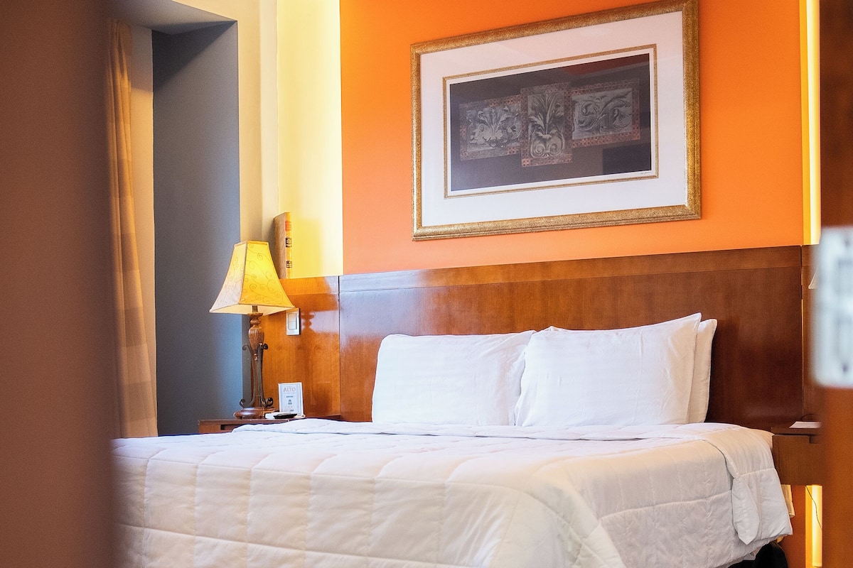 Premium bedding, laptop workspace, iron/ironing board