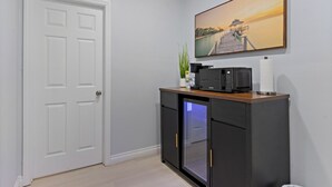 A compact kitchen with a microwave, a coffee maker, and a refrigerator. - Relax & Unwind - Cozy 1 BR w/ Room for 5 Guests (San Diego)