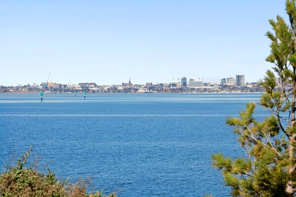 A coastal cityscape with a clear view of the waterfront and buildings in the distance.