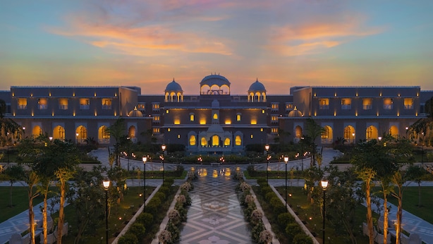A large, multi-story building with a symmetrical facade, featuring multiple windows and domed structures. - Taj Lalit Bagh, Udaipur (Māvli)