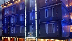 A multi-story building with a sign reading "Vazudeva" at the top. - ECKO Vasudeva (Joshimath)