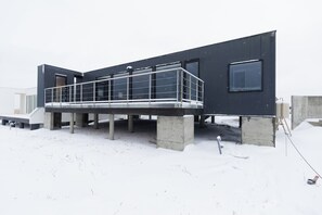 A modern building with a covered walkway and concrete supports. - Yunagi  (Ishikari)