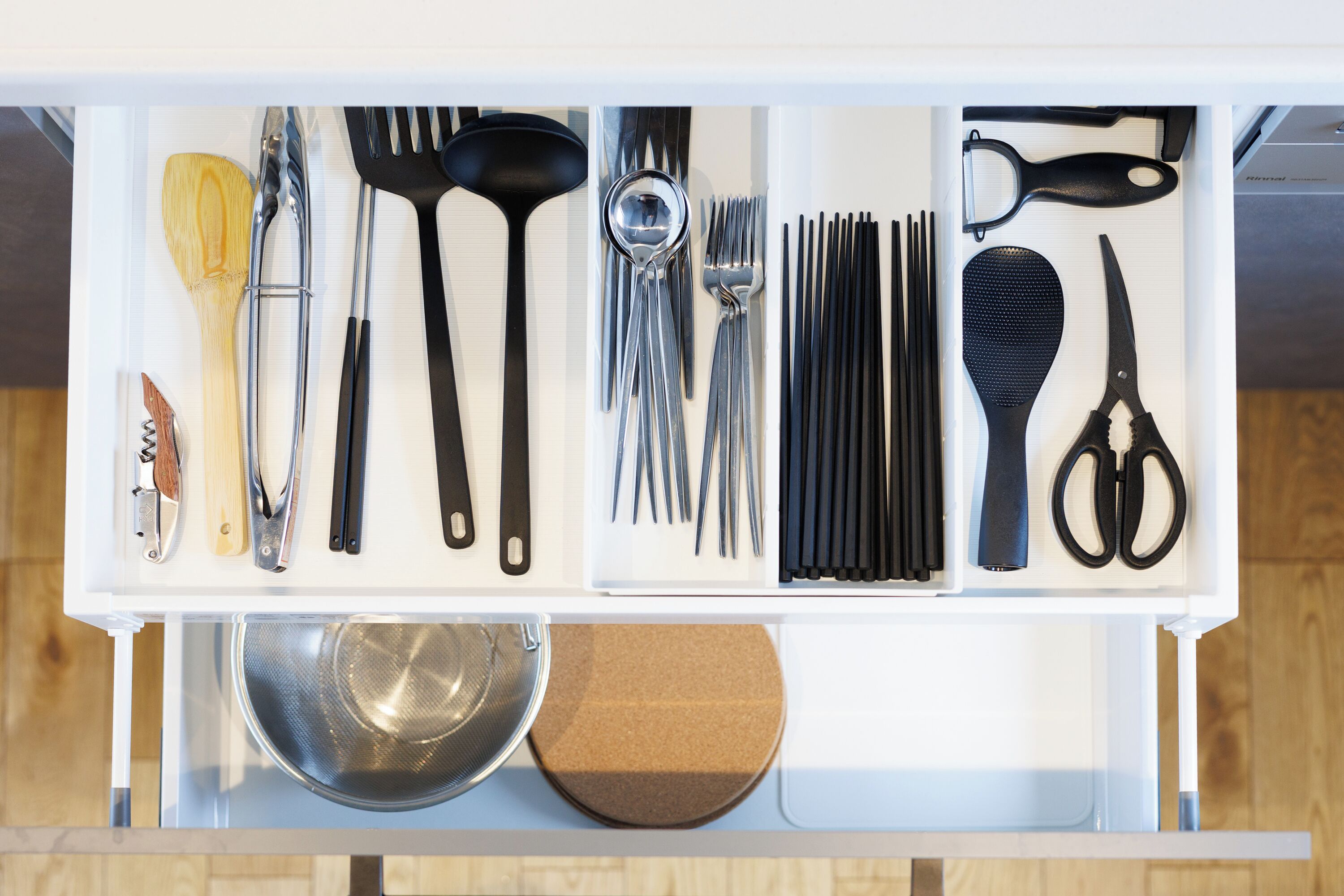 A kitchen drawer with utensils and kitchen tools.