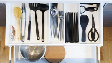 A kitchen drawer with utensils and kitchen tools.