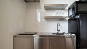 A modern kitchen with stainless steel appliances, a sink, and a countertop.