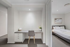 Escritorio, tabla de planchar con plancha, wifi y ropa de cama