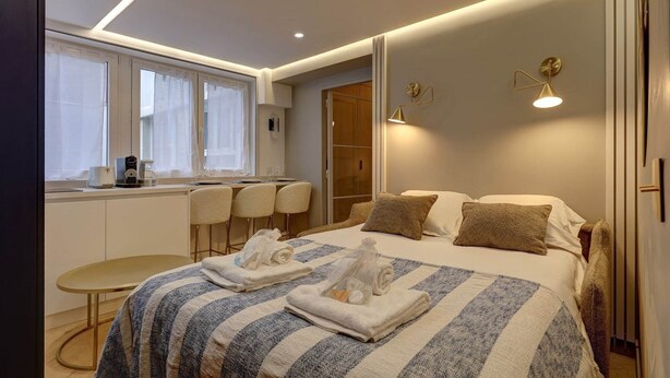 Ein modernes Hotelzimmer mit Bett, Schreibtisch und Sitzecke.