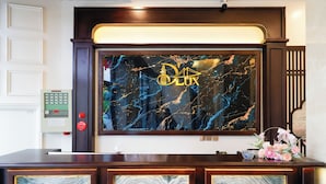 A reception desk with a marble display and a control panel. - D'Lux Hotel (Hanoi)