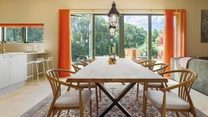 A dining area with a large table, chairs, and a hanging light fixture. - Gorgeous home in Spøttrup with sauna (Spøttrup)