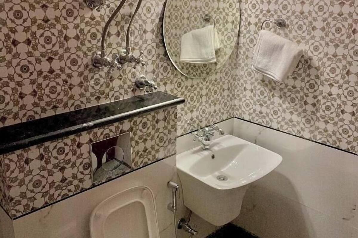 A bathroom with a toilet, sink, and shower.