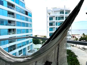 A view of a modern building with multiple floors and balconies, overlooking a body of water. - Luxurious 3-bedroom Apartment With Shared Pool in Bolívar (Cartagena)