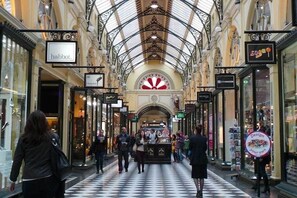 A shopping mall with a checkered floor, ornate ceiling, and various stores including 'habbot' and 'sugoo'.
