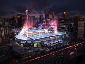 A stadium with a large, curved roof and multiple levels of seating. - A Cozy 2BR Apt Next to Southern Cross Free Parking (Melbourne)