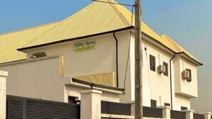A building with a sign that reads "Infinity Luxury Apartments." - Infinity Luxury Apartment (Bwari)