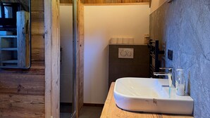 A wooden interior with a sink, mirror, and wooden bench. - Chalet “Mazot De La Pointe Percée” with Balcony (Combloux)