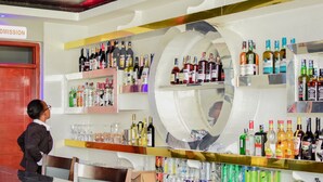A bar area with shelves of various liquor bottles, glasses, and cans. - Bijou Hotel Mlolongo (Mlolongo)