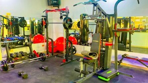 A gym with various exercise equipment, including weight machines, free weights, and cardio machines. - Bijou Hotel Mlolongo (Mlolongo)