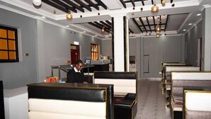 A hotel lobby with seating areas, a reception desk, and a modern chandelier. - Bijou Hotel Mlolongo (Mlolongo)