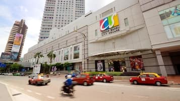 A modern building with a prominent 'City Square' sign, surrounded by busy traffic and palm trees.