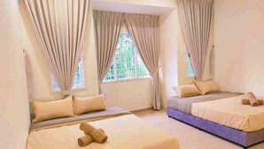 A hotel room with two beds, beige curtains, and a view of greenery outside. - Indahpura Kulai (Kulai)