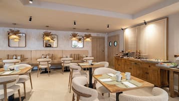 A restaurant with a long counter, multiple seating areas, and a variety of dishes displayed.