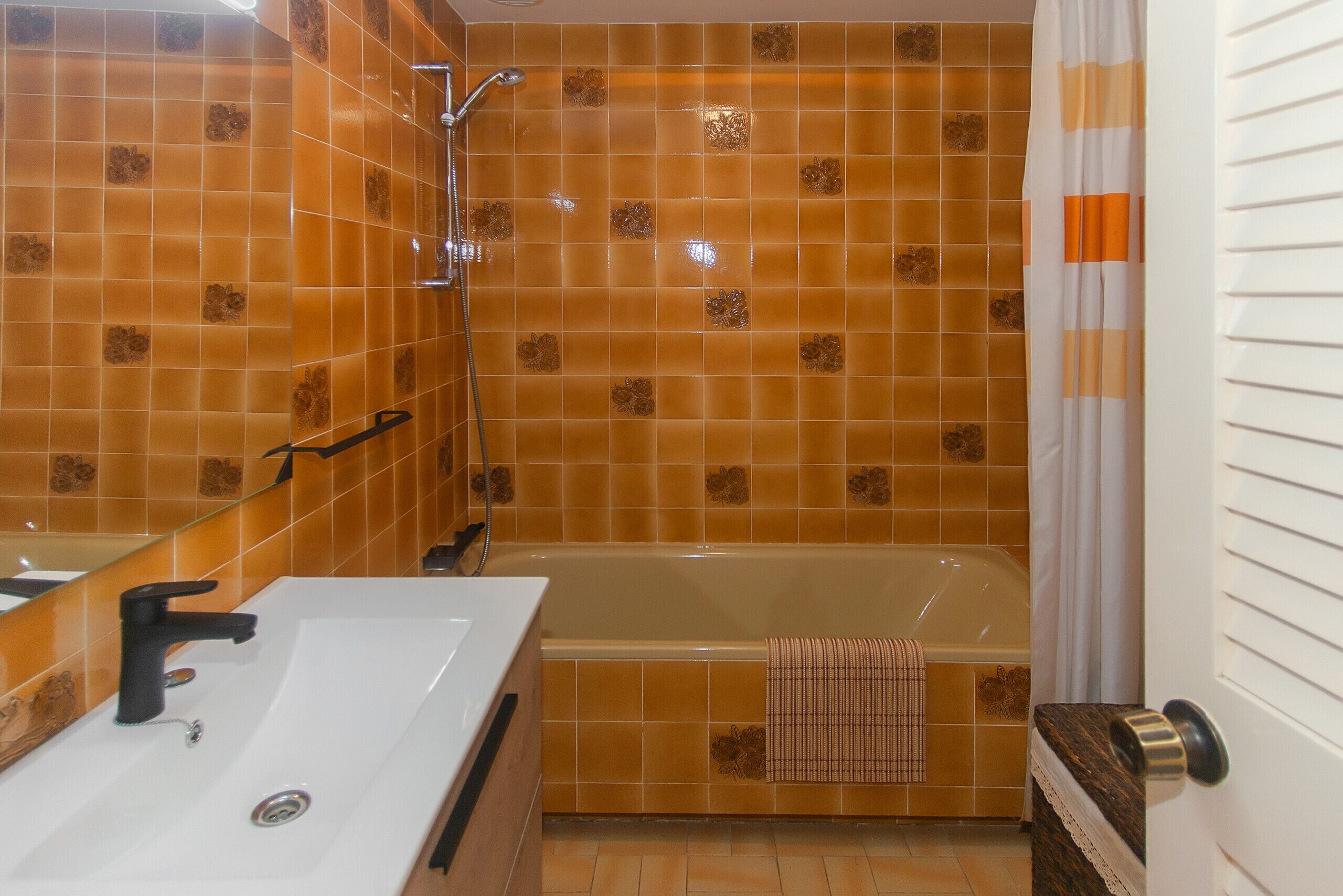 A bathroom with a bathtub, a sink, and a shower.