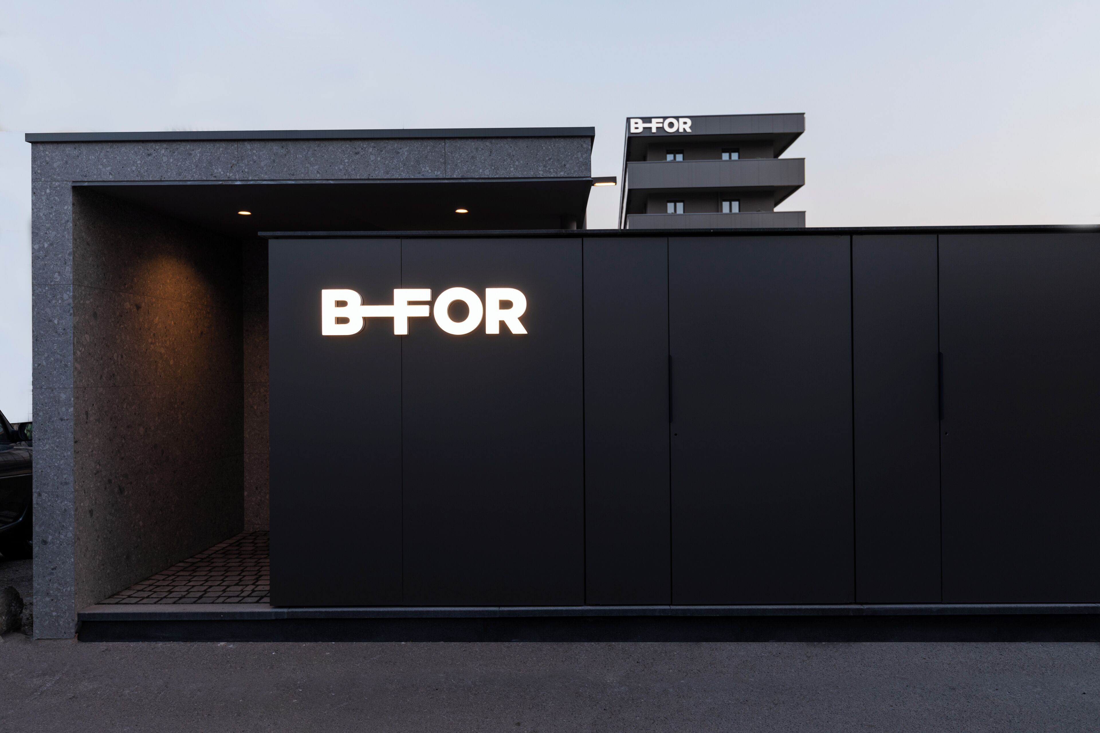 A modern building with a prominent 'B-FOR' sign on the facade.