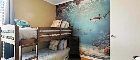 A bunk bed room with a mural of an underwater scene.