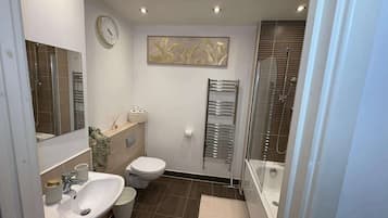 Shower, hair dryer, towels, shampoo