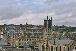 A historic building with a clock tower, featuring Gothic architecture and a prominent clock face. - Student Only Oldgate House (Huddersfield)