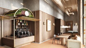 A modern interior with a coffee bar, seating area, and a large window. - Ocean View Aparthotel (Southampton)