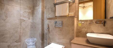A bathroom with a toilet, sink, and towel rack.