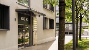 Een gebouw met een bordje 'BOB W.' en een glazen deur.