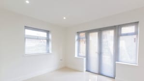 An empty room with white walls, a glossy floor, and large windows with blinds. - Bridge Road - Room 1 (Southampton)
